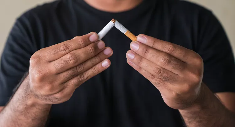 Close up of hand breaking cigarette